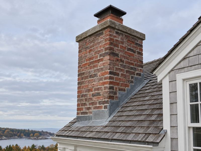Illustrative view of a brick chimney and roofline